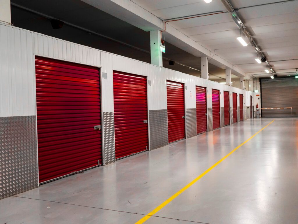 Long row of red color doors of self storage facility.